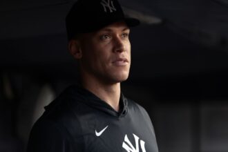 Aaron Judge could miss MLB wild card series after calf injury Judge, dressed in formal attire, watching his teammates play