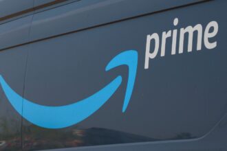 Amazon Prime begins automatic refunds of up to $200 for eligible customers An Amazon truck with the company’s logo and name on one of its sides.