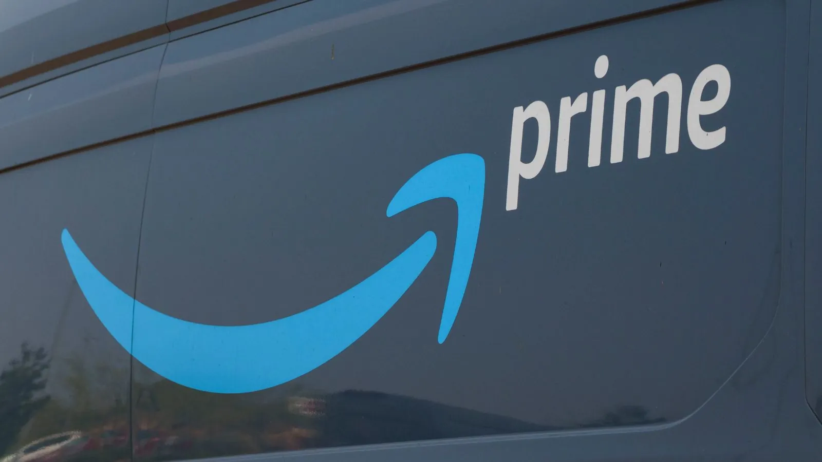 Amazon Prime begins automatic refunds of up to $200 for eligible customers An Amazon truck with the company’s logo and name on one of its sides.