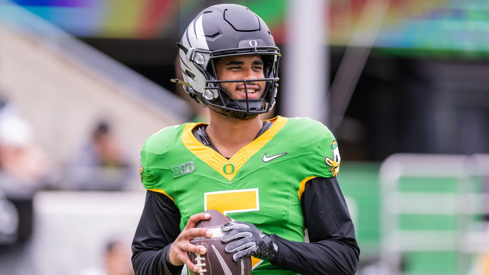 Dante Moore emerges as the favorite to be the top quarterback in the 2027 NFL Draft The young pitcher smiling at the cameras while holding his helmet