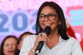 Delcy Rodríguez says Venezuela will hold elections but gives no date Venezuela’s current leader smiling broadly while being applauded and accompanied by her supporters
