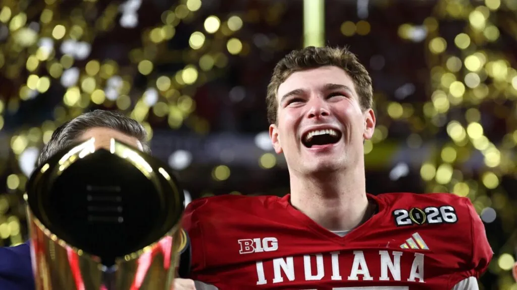 The young quarterback lifting the NCAA trophy after winning with Indiana