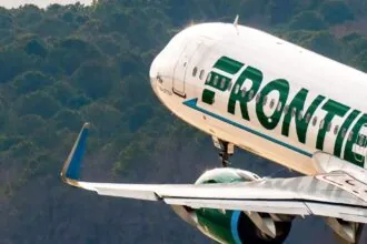 A white Frontier Airlines plane is photographed as it takes off