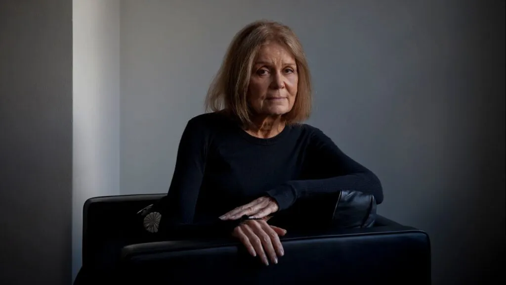 The well-known philanthropist posing for the cameras while sitting on a piece of furniture