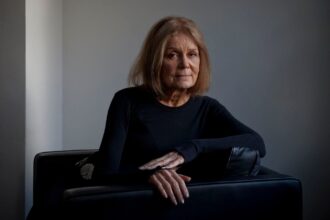 The well-known philanthropist posing for the cameras while sitting on a piece of furniture