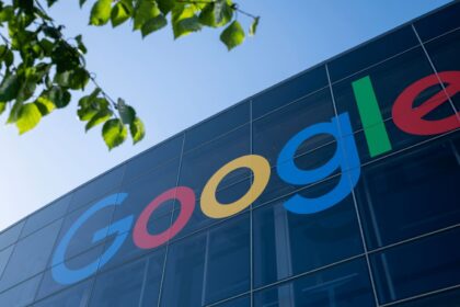 A Google sign attached to a large building with huge glass windows