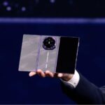 Huawei unveils Mate XT2: The $3,000 foldable phone that turns into a tablet A person holding the new Huawei triple-screen phone in their hand