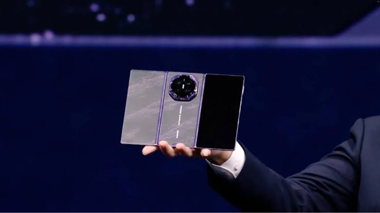 Huawei unveils Mate XT2: The $3,000 foldable phone that turns into a tablet A person holding the new Huawei triple-screen phone in their hand