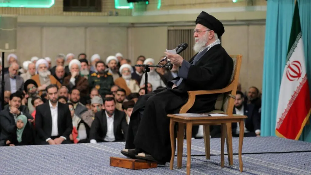Iran threatens to intensify attacks on United States ships in the Middle East The leader of the Iranian regime sitting in a chair while surrounded by his followers