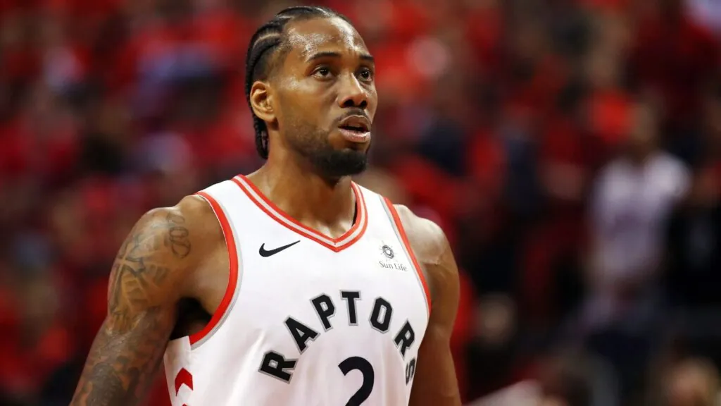 Kawhi Leonard agrees to new $115 million extension with the Toronto Raptors A young Leonard wearing a Raptors uniform, about to take a free throw