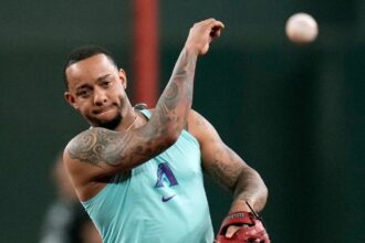 Ketel Marte throwing a baseball to one of his teammates during warm-ups