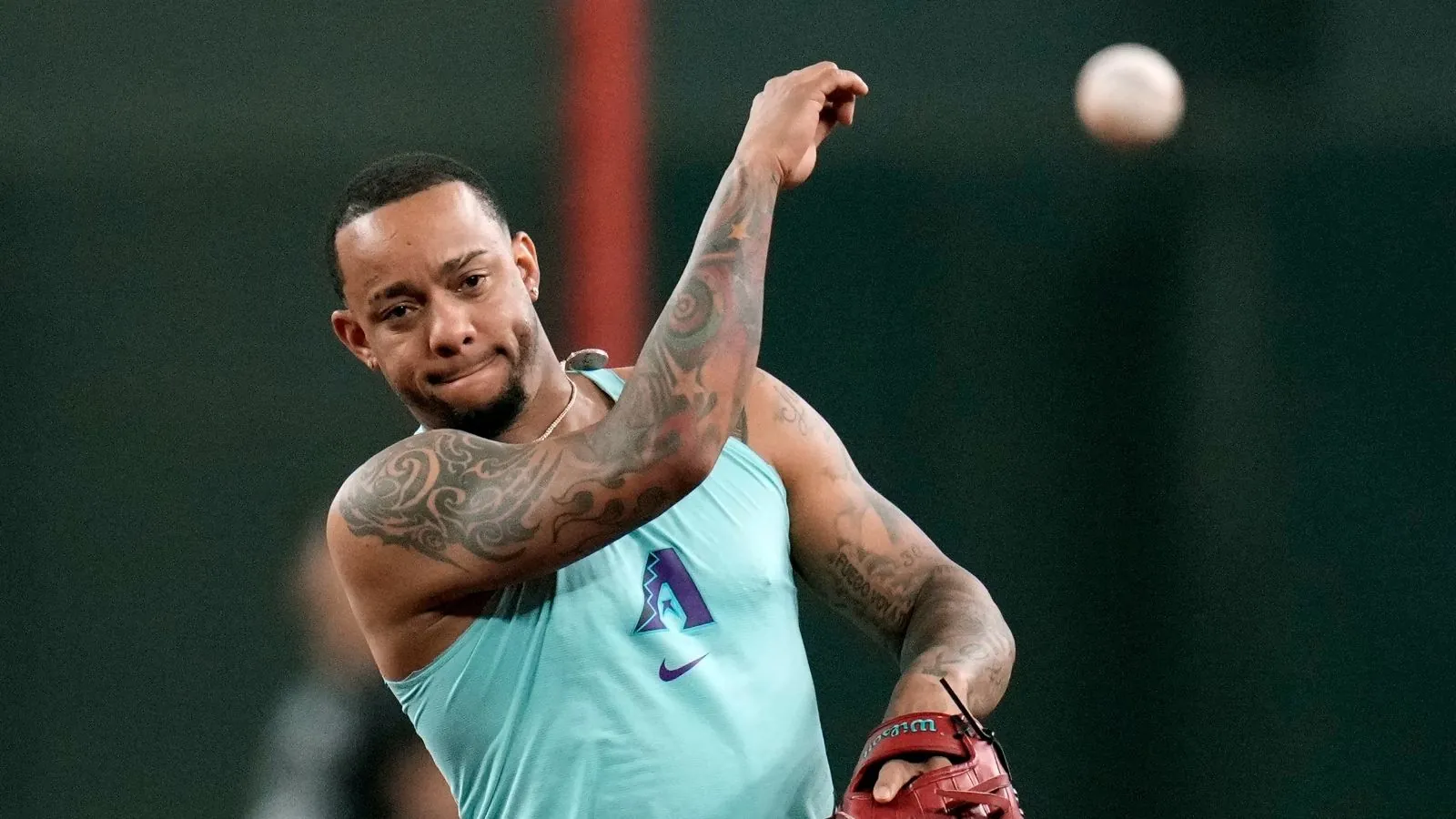 Ketel Marte throwing a baseball to one of his teammates during warm-ups