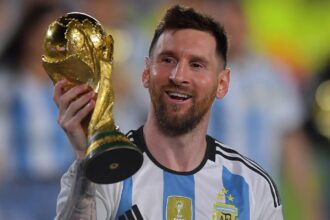 Leo Messi makes major donation to help children with cancer The Argentine star holding the World Cup trophy with one hand while smiling and showing it to the crowd