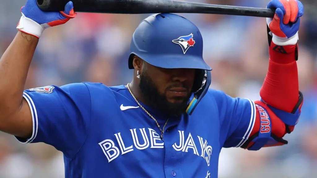 Vladimir Guerrero Jr. holding his bat above his head after a rough slump at the plate