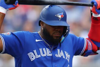 Vladimir Guerrero Jr. holding his bat above his head after a rough slump at the plate