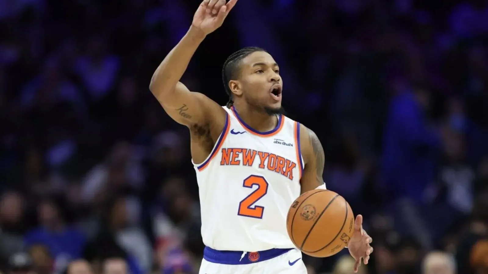 The important NBA point guard raising his index finger while signaling a new play to his teammates