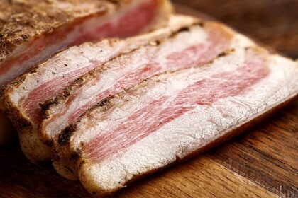 A partially prepared piece of pork, cut and portioned