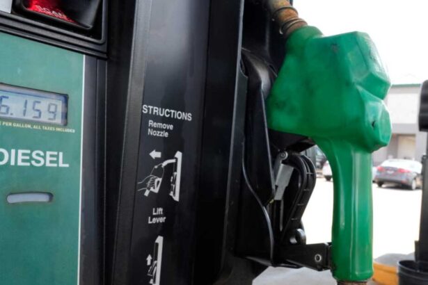 A green diesel fuel pump with the product prices displayed on one side