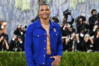 Russell posing for the cameras in a blue outfit at the Met Gala