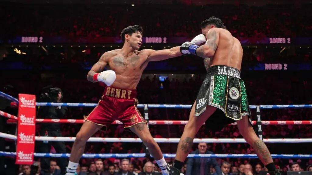 Ryan landing a punch on his opponent during a fight in the ring