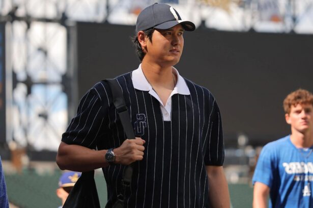 The Japanese star walking across the field in casual clothes while carrying his personal bag