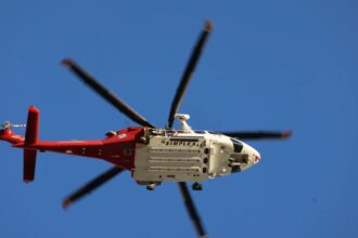 Three dead after news helicopter crashes in Los Angeles while covering a story A white and red helicopter flying through the sky