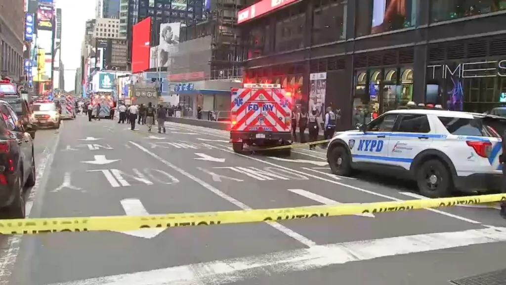 Many police cars and ambulances are parked with their sirens on while assisting the attacker