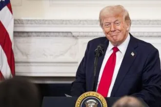 Trump smiling at a press conference from the White House