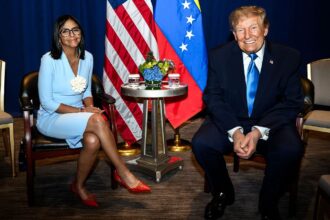 The leaders of each country sitting down and smiling at the camera