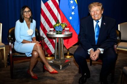 The leaders of each country sitting down and smiling at the camera