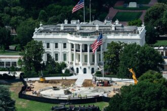 Trump blocks CNN, MS NOW and Politico from the White House A panoramic image of the White House, with renovations taking place in certain parts of its garden