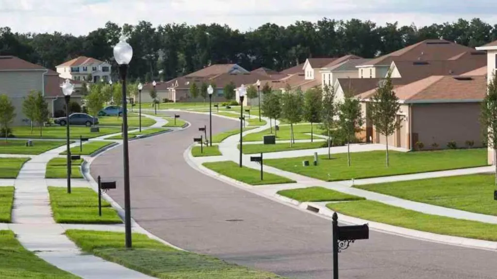 An American neighborhood with many houses, sidewalks, and beautifully maintained green spaces