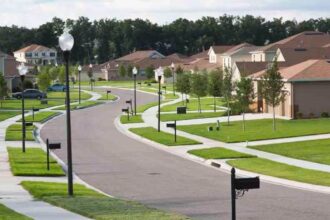 An American neighborhood with many houses, sidewalks, and beautifully maintained green spaces