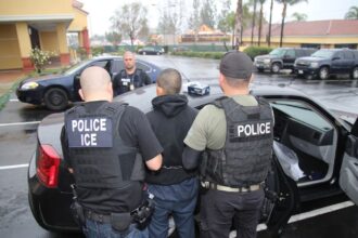 United States homeowner accused of using ICE threat to avoid paying latino workers Several ICE agents escorting a Latino man into one of their vehicles